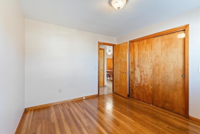 unfurnished bedroom with hardwood / wood-style floors and a closet