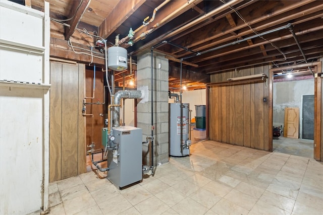 basement featuring wooden walls and water heater