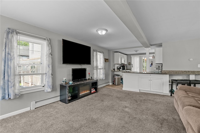 living room with light carpet, baseboard heating, and beamed ceiling