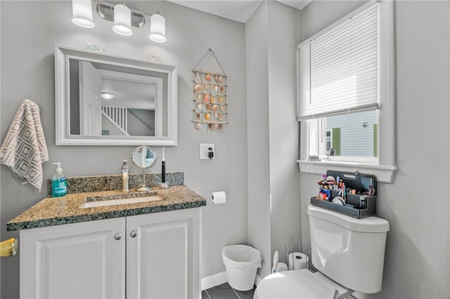 bathroom featuring tile patterned flooring, vanity, and toilet