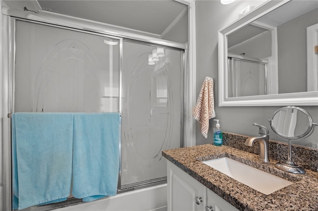 bathroom with combined bath / shower with glass door and vanity