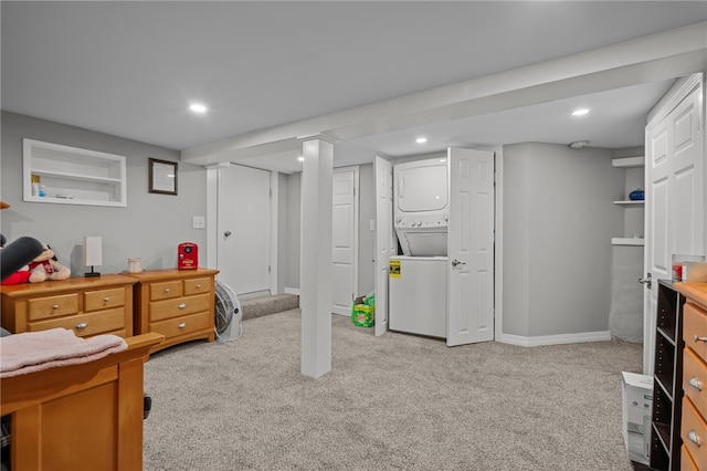 bedroom with light carpet and stacked washing maching and dryer