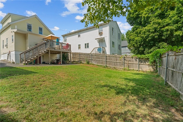 back of property with a lawn and a deck