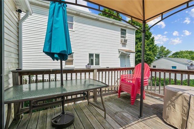 wooden deck featuring a gazebo and cooling unit