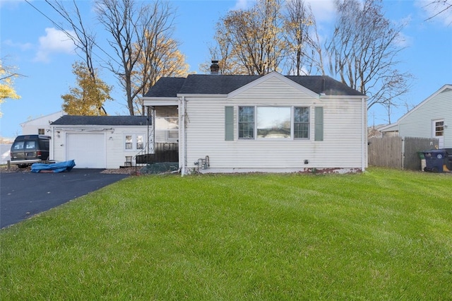 view of front of house with a garage and a front lawn