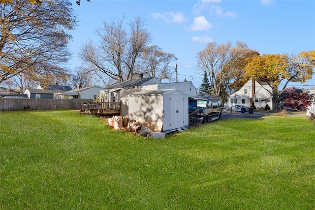 view of yard featuring a shed and a wooden deck