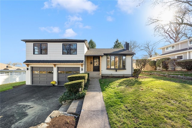 split level home featuring a front yard and a garage