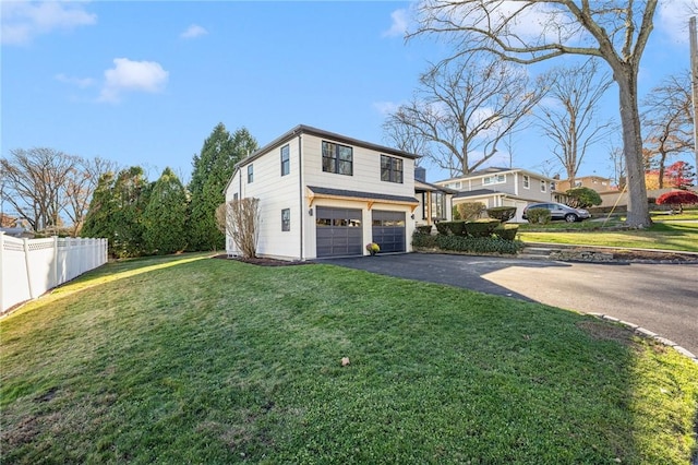 view of side of home featuring a garage and a lawn