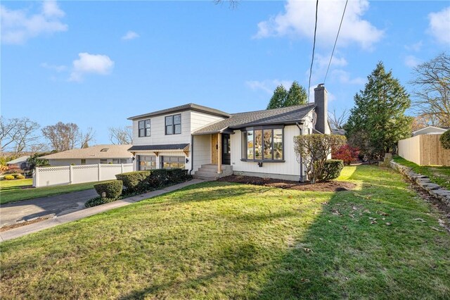 split level home featuring a front lawn