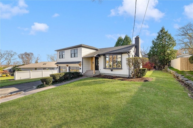 split level home featuring a front lawn