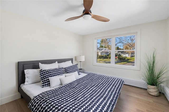 bedroom with ceiling fan and wood-type flooring