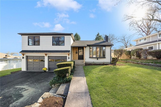 split level home with a front lawn and a garage