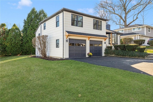 view of front of house featuring a front yard and a garage