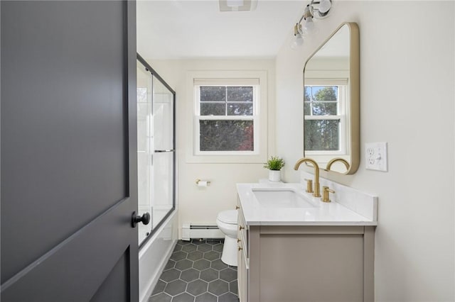 full bathroom with vanity, a baseboard radiator, tile patterned flooring, toilet, and enclosed tub / shower combo