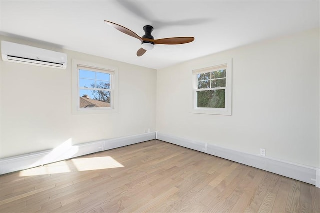 empty room with ceiling fan, light hardwood / wood-style flooring, and an AC wall unit