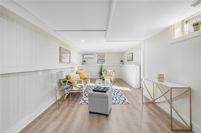 living area featuring light wood-type flooring and a wall mounted AC