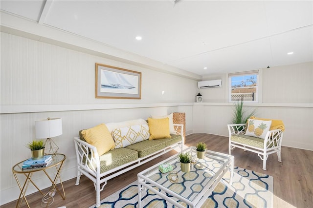 living room with hardwood / wood-style flooring and a wall unit AC