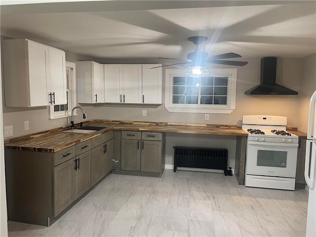 kitchen featuring butcher block countertops, radiator, gas range gas stove, and extractor fan