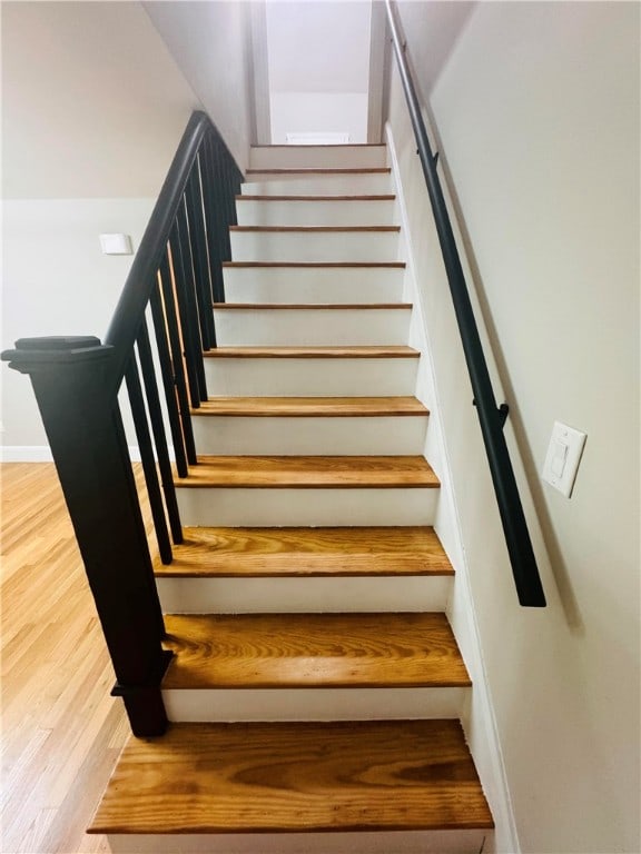 staircase featuring hardwood / wood-style flooring