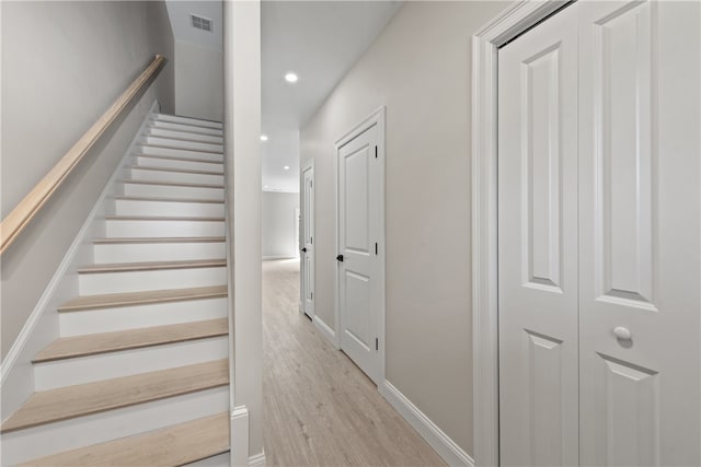 stairs featuring wood-type flooring