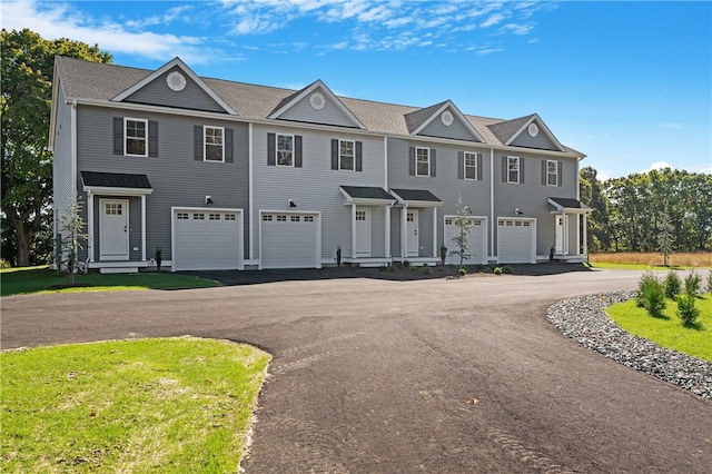 view of front of home with a garage and a front lawn