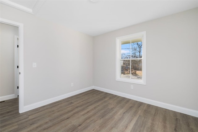 empty room with dark wood-type flooring