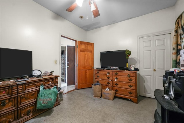 carpeted bedroom featuring ceiling fan and a closet