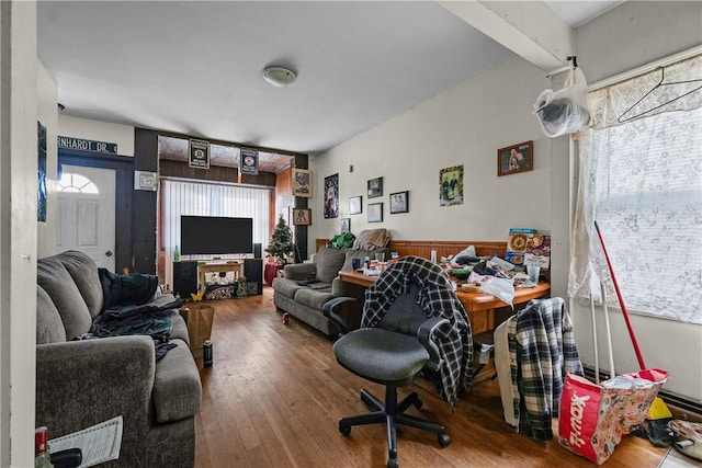 living room with wood walls and hardwood / wood-style floors