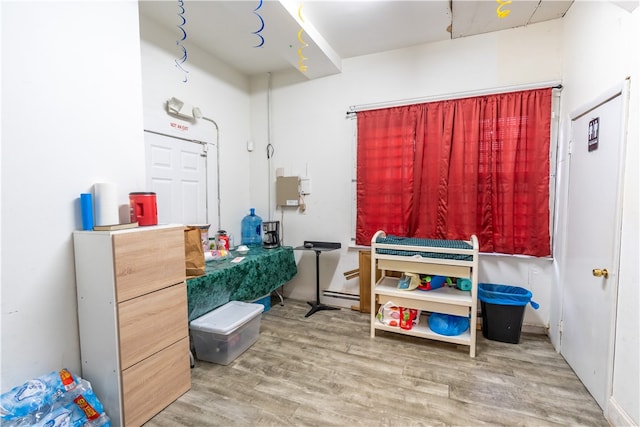 miscellaneous room featuring hardwood / wood-style floors and a baseboard radiator