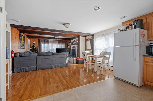 living room with beamed ceiling and light hardwood / wood-style flooring