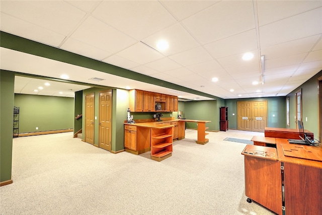 interior space with light colored carpet and a drop ceiling