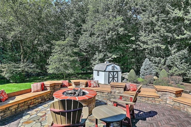 view of patio featuring a shed and a fire pit