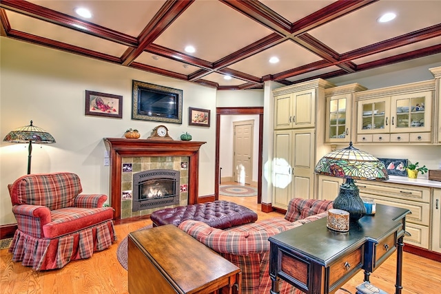 living room featuring a fireplace, light hardwood / wood-style flooring, beamed ceiling, and coffered ceiling