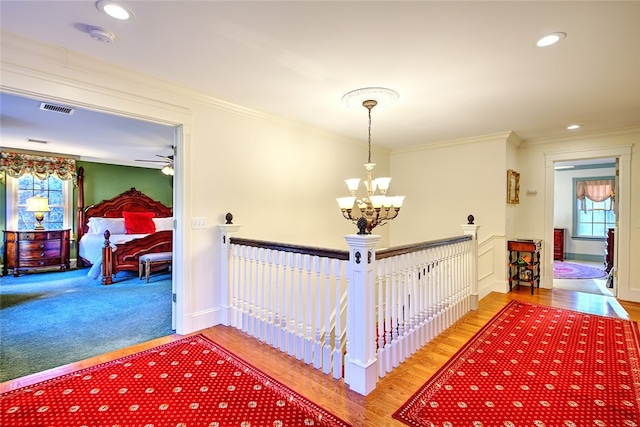 corridor featuring a chandelier and ornamental molding