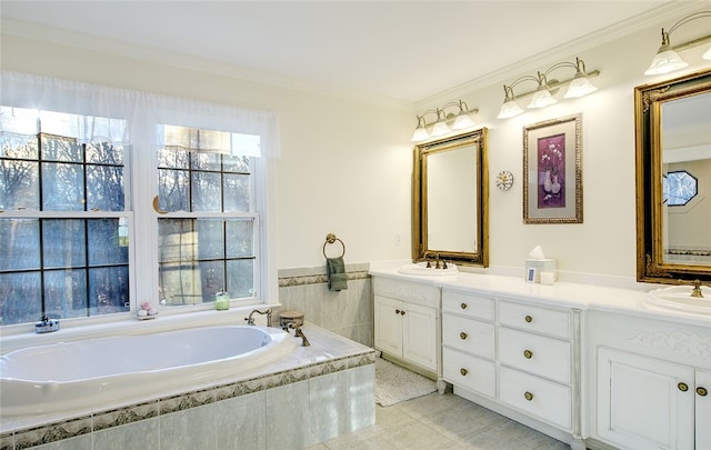 bathroom featuring tiled tub, crown molding, tile patterned flooring, and vanity