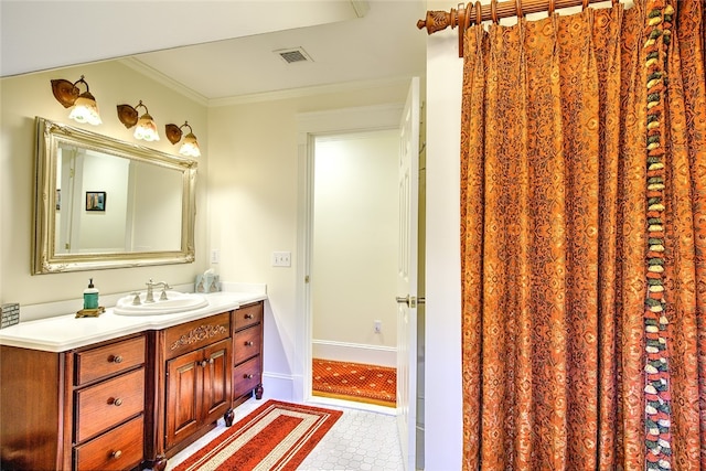 bathroom with tile patterned floors, vanity, and ornamental molding