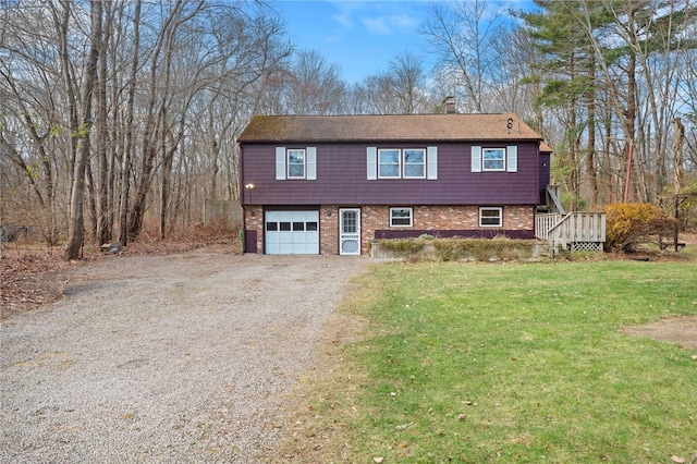 view of front of property with a wooden deck, a front lawn, and a garage