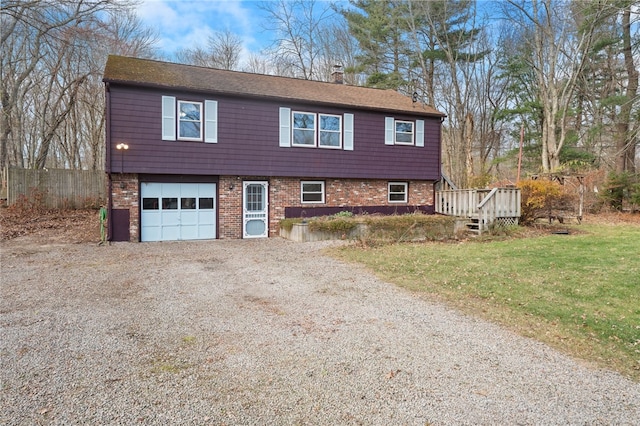 view of front of property with a front yard, a deck, and a garage