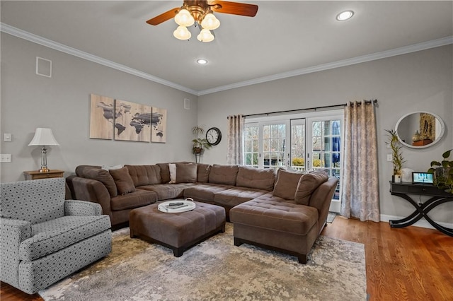 living room with ceiling fan, ornamental molding, and hardwood / wood-style floors