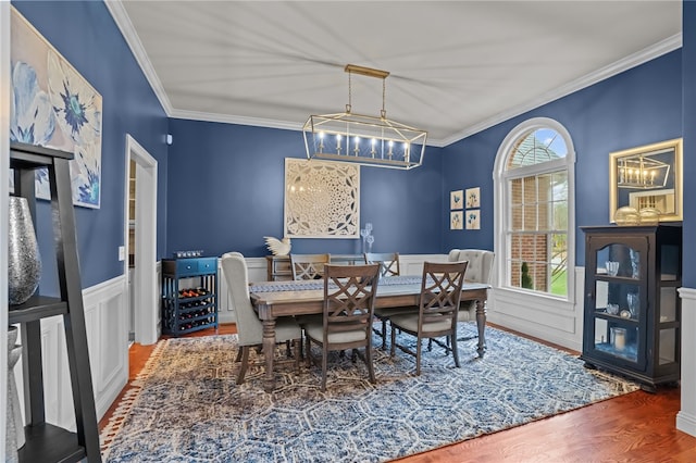 dining room featuring plenty of natural light, crown molding, and an inviting chandelier