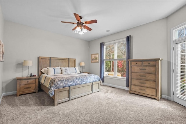 carpeted bedroom featuring ceiling fan, access to exterior, and multiple windows