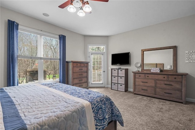 bedroom with access to outside, light colored carpet, and ceiling fan