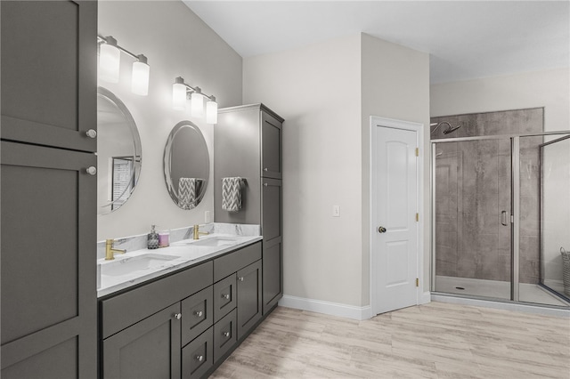 bathroom with vanity, wood-type flooring, and walk in shower