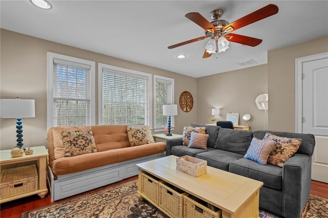 living room with ceiling fan and dark hardwood / wood-style flooring