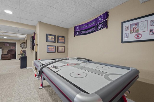 game room with carpet floors and a paneled ceiling