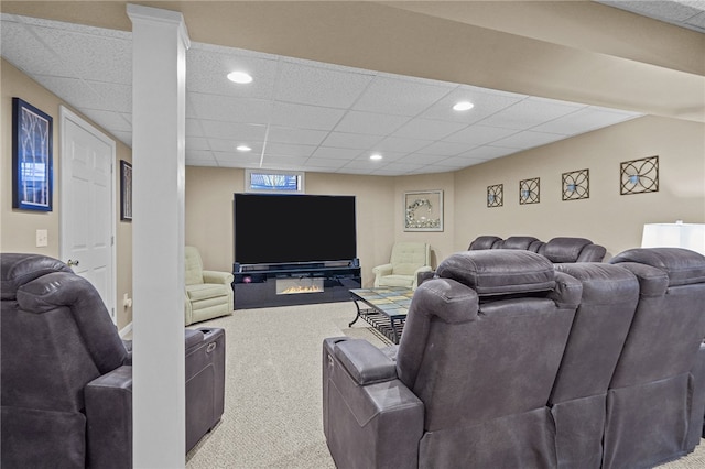 living room featuring a paneled ceiling and light colored carpet