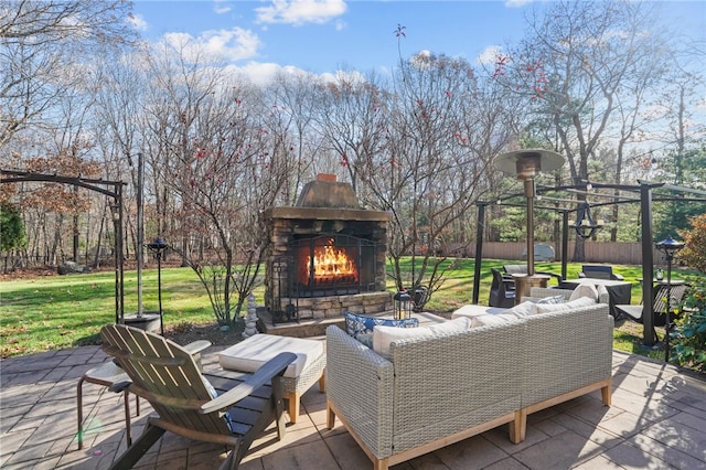 deck with an outdoor living space with a fireplace, a patio, and a lawn