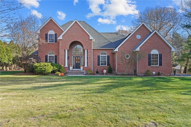 view of front facade featuring a front lawn and brick siding