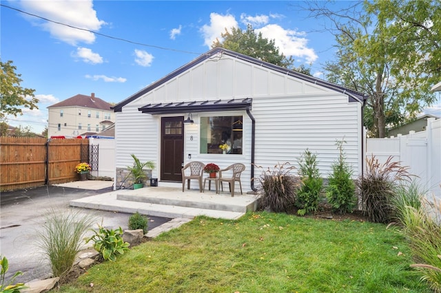 rear view of property featuring a yard