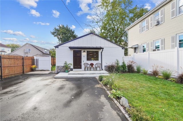 exterior space featuring a front yard and cooling unit